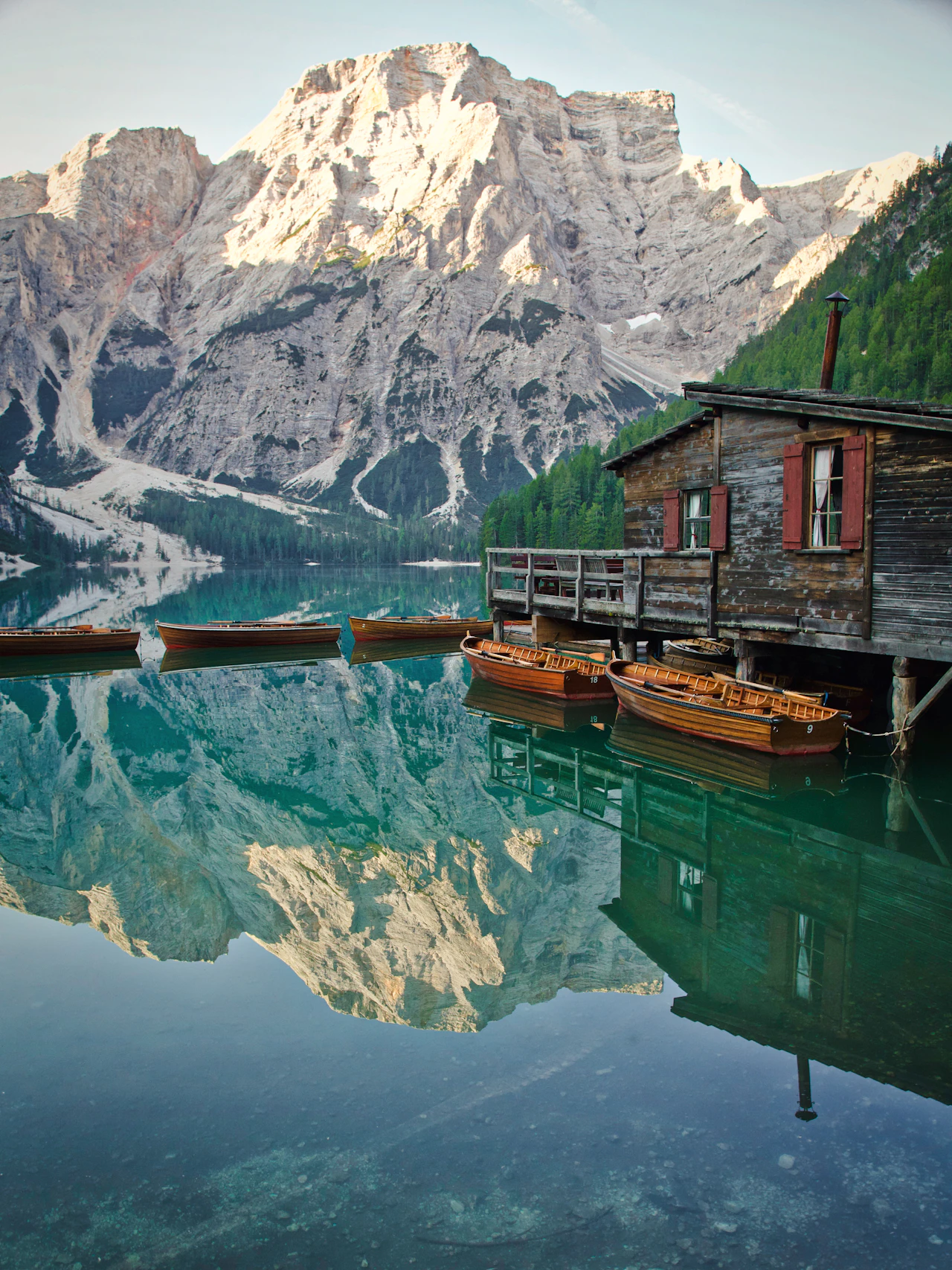 Wooden boats on an alpine lake beneath the mountains
